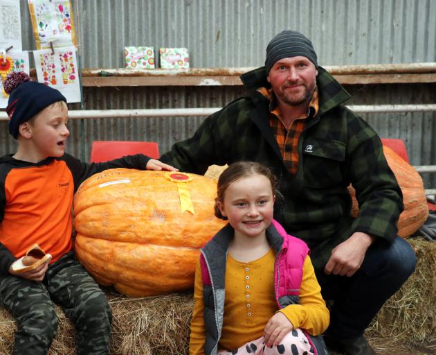 Hamish Wilson (right) won the title for largest pumpkin grown by an adult. He is pictured with...