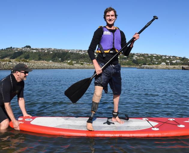 Lower-leg amputee Ben Walker is rock steady on his first attempt at paddle boarding, thanks to...