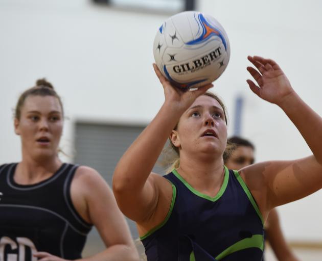 Markham's College's Billie Scurr prepares to shoot as Southern Tui defender Penny Johnson looks on at the Dunedin netball pre-season tournament at the Edgar Centre on Saturday. Photo: Gregor Richardson