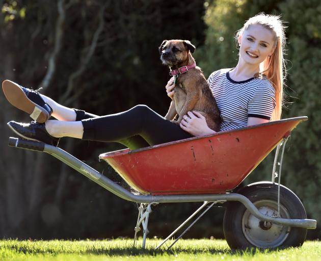 Victorian State Ballet dancer Rebecca Murray puts her feet up with Twig, the family dog, during...