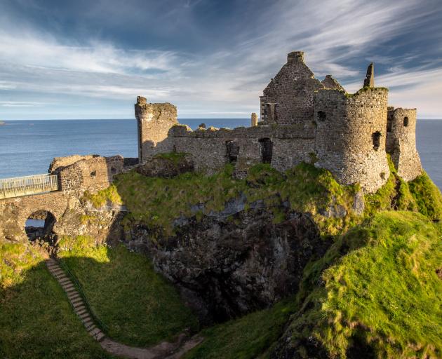 Dunluce Castle sits perched on the dramatic coastal cliffs of north County Antrim. Photos: Getty...