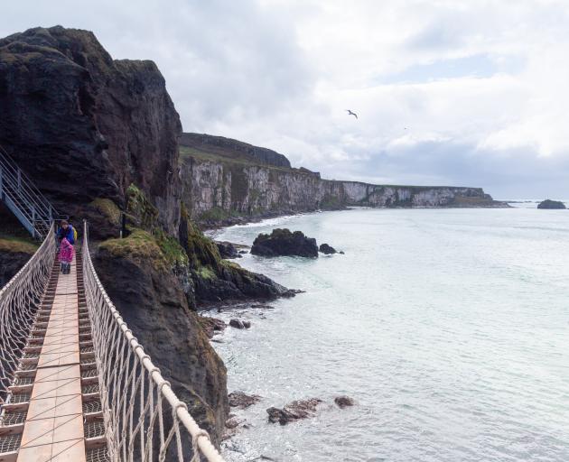 Carrick-a-Rede rope bridge connects the cliffs to a small island. 