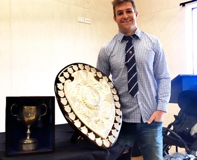 Blues and Otago fullback Michael Collins with the Ranfurly Shield and White Horse Cup after...