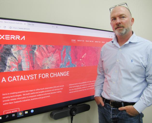 Xerra Earth Observation Institute Ltd chief executive Steve Cotter stands beside the rebranded...