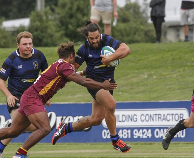 Excelsior centre Taina Tamou tries to fend Athletic Marist winger Simon Lilicama during a...