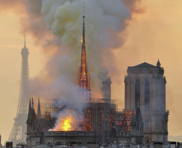 Flames and smoke rise from the blaze at Notre Dame Cathedral, with another famour landmark, the...