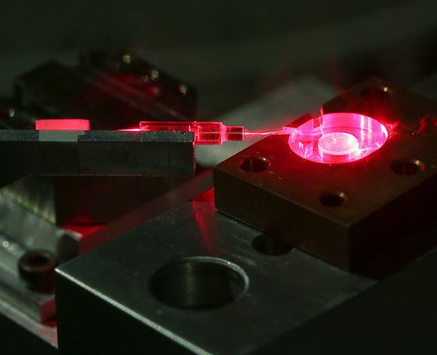 A tiny crystal disc, visible at right, is part of an energy-saving device which could help...