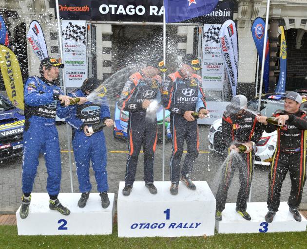 Otago Rally winners Hayden Paddon and John Kennard are sprayed by Ben Hunt and Tony Rawstorn ...