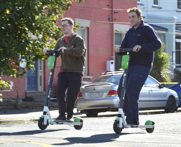 University of Otago students Luke Beer (left) and Levi Milton zoom through North Dunedin on Lime...