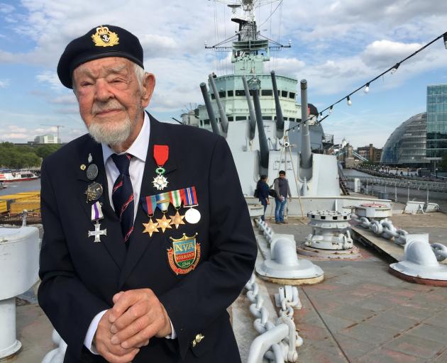 D-Day veteran Richard Llewellyn poses for a photograph on HMS Belfast, on the River Thames in...