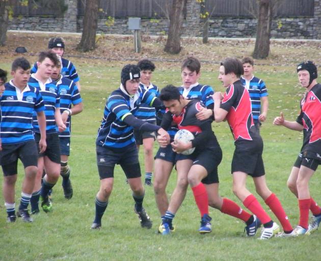 Twizel (red) and Maniototo 1st XVs engaged in a highly physical encounter. 
