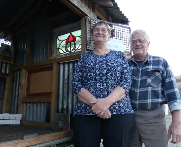 Melanie and Maurice Hillier show the honesty box on the floor of their roadside cabin that was nearly purloined by a would-be thief. Photos: Simon Henderson