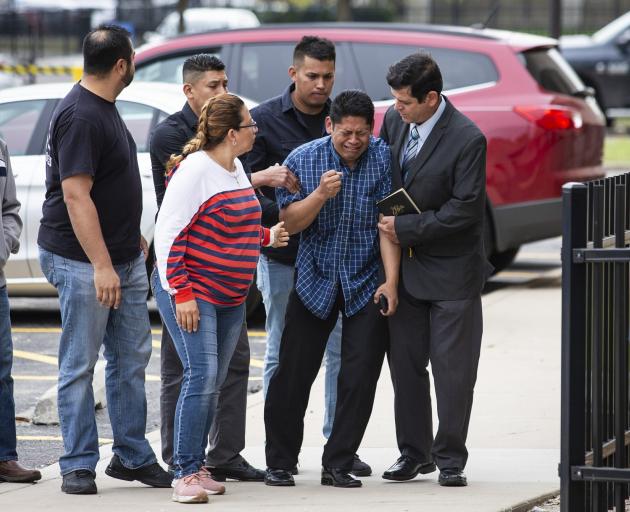 Arnulfo Ochoa is surrounded by family members and supporters, as he walks into the Cook County medical examiner's office to identify his daughter's body. Photo: Chicago Sun-Times via AP