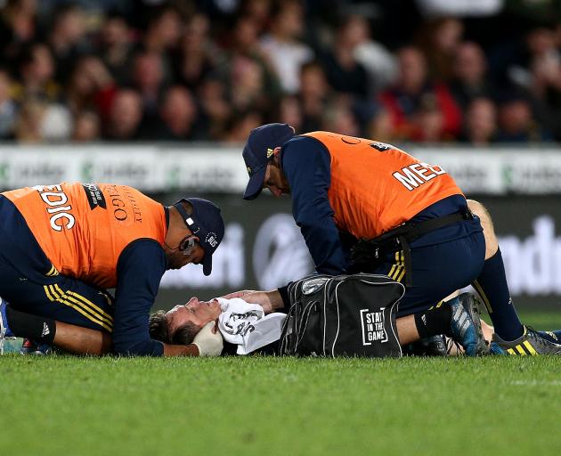 Ben Smith lays prone on the ground after a nasty collision in which he also pulled a hamstring....