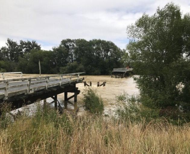 The 50m metre section of bridge over the Mataura River was knocked out by floodwaters. Photo:...