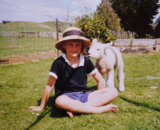 Busby as a lamb with four-year-old Olivia. Photo: Supplied