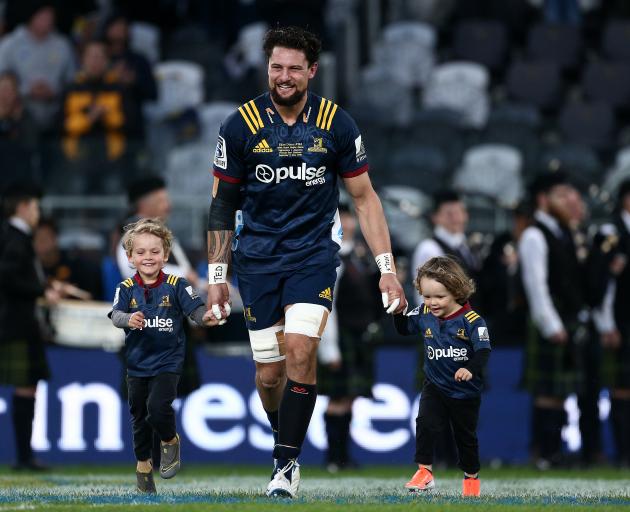 Elliot Dixon runs onto the field with his biggest fans for his 100th Super Rugby match for the...