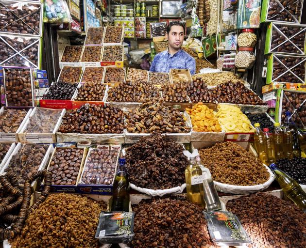 A man sells dates and other dried fruits in one of the thousands of stalls in the souks of Fez.