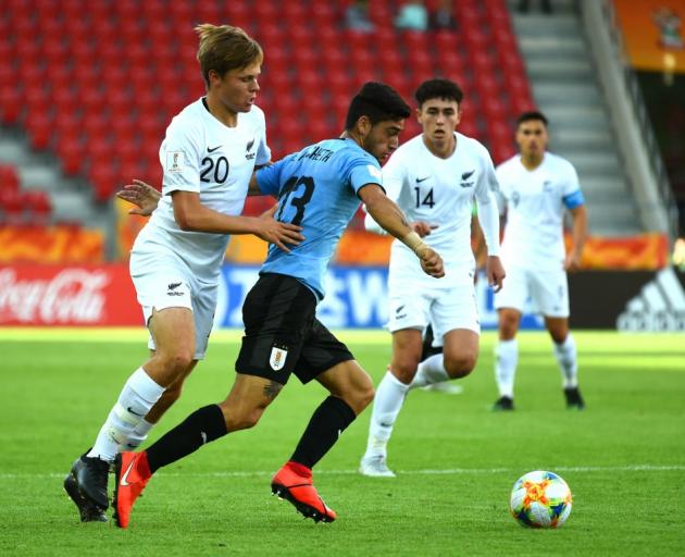 Emiliano Ancheta of Uruguay and Willem Ebbinge of New Zealand compete for the ball during their...