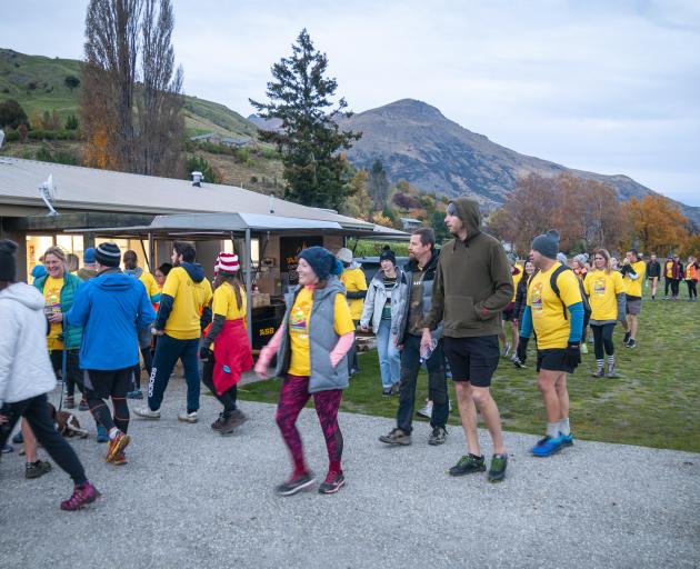 Participants in the ``Darkness Into Light'' walk arrive back at the Lake Hayes Pavilion near...