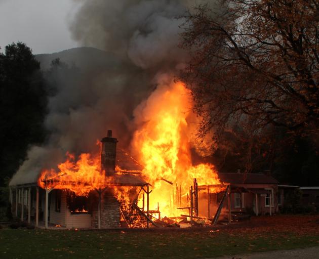 The 133-year-old homestead on fire. PHOTO: PARADISE TRUST