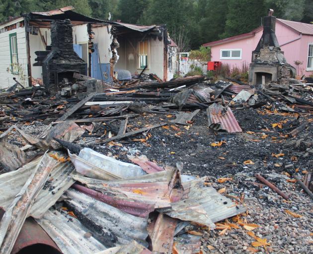 The homestead’s charred remains, with the surviving accommodation wing at left. PHOTO: PARADISE...