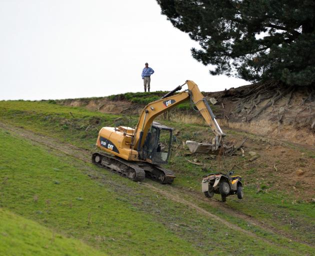 Contractors remove a quad bike from a Waihola farm in September 2014, after it was involved in an...