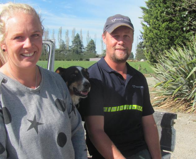 Pencarrow Farm contract milkers Viana and Brad Fallaver with dog Flow, the inspiration behind...