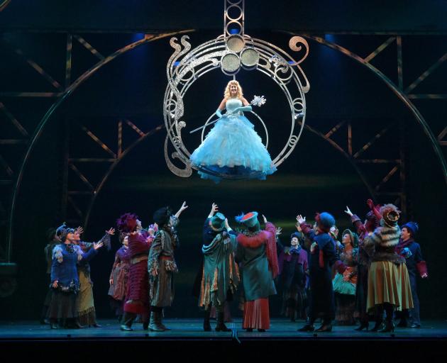 Kelly Hocking (Glinda) soars above the chorus in the opening number of the Musical Theatre Dunedin production of Wicked. Photo: Linda Robertson