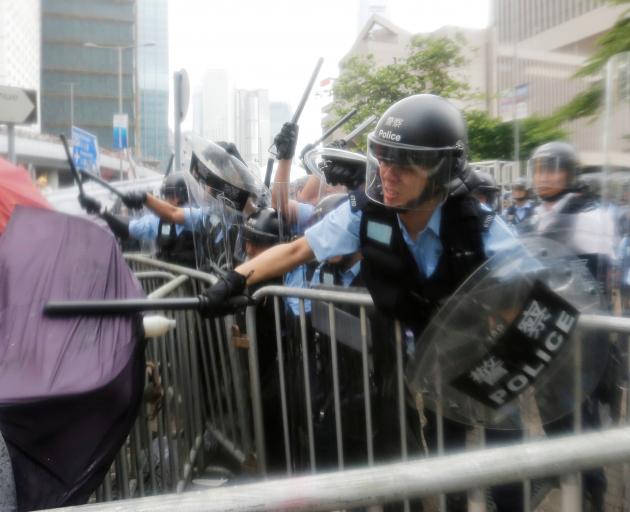 Police use batons on protesters demonstrating against a proposed extradition law to China in Hong...