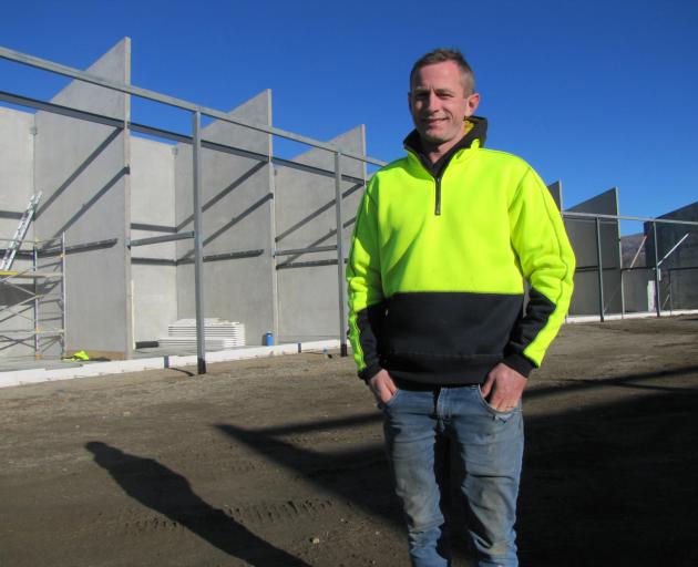 General Construction manager Bryce Geary is flanked by stage one of the $10 million dollar AC/JV...