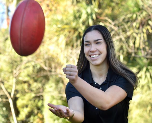 Talented netballer and University of Otago student Killarney Morey plays around with an AFL ball yesterday before leaving for her home town of Auckland. Photo: Peter McIntosh