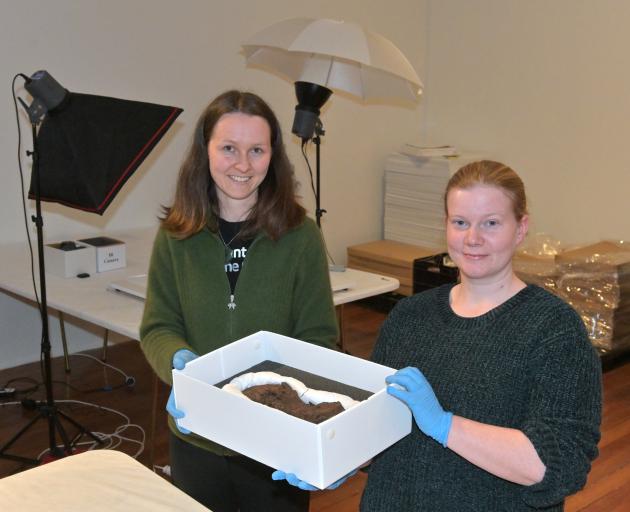 Southland Museum collections manager Kimberly Stephenson (left) and collections technician Laura Davies unpack an 18th or 19th-century sealer’s boot, which will be on display during the ‘‘Coastal Flows / Coastal Incursions’’ exhibition. Photo: Linda Rober