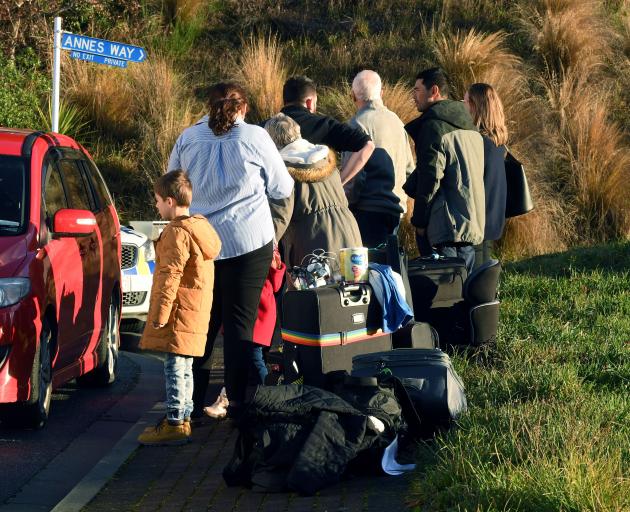People gathered outside a Queenstown house which was "completely smoke-logged" this morning....