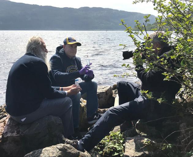 Neil Gemmell (centre) on the shores of Loch Ness. PHOTO: Supplied 