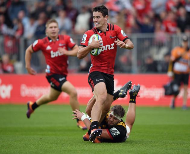 Crusaders fullback Will Jordan eases through a tackle. Photo: Getty Images 