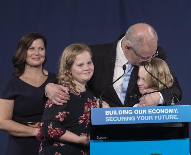 Australian PM Scott Morrison hugs his daughters Lily and Abbey as wife Jenny watches following...