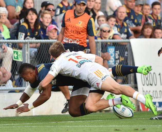 Naholo beats the defence of Reds players Eto Nabali and Duncan Paia'aua to score in the corner...