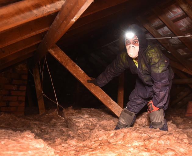 WarmUp Solutions installer Muhammad Hassen (22) installs insulation at a Russell St property, in...