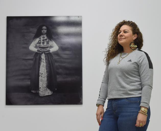 Artist Jasmine Togo-Brisby with one of her works, Ask the Sea, from her Otago Polytechnic...