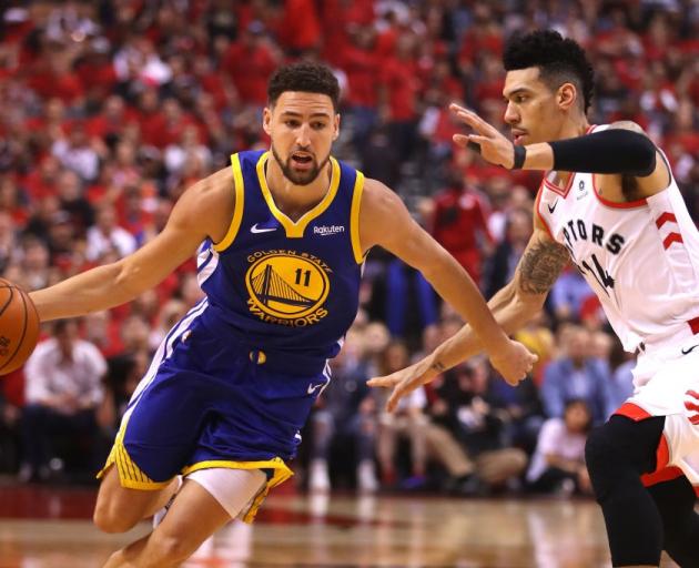Klay Thompson (left) takes the ball to the hoop against Danny Green on Monday during game two of...