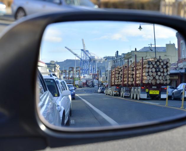 A log truck rumbles through the main street of Port Chalmers on its way to Port Otago's wharf....
