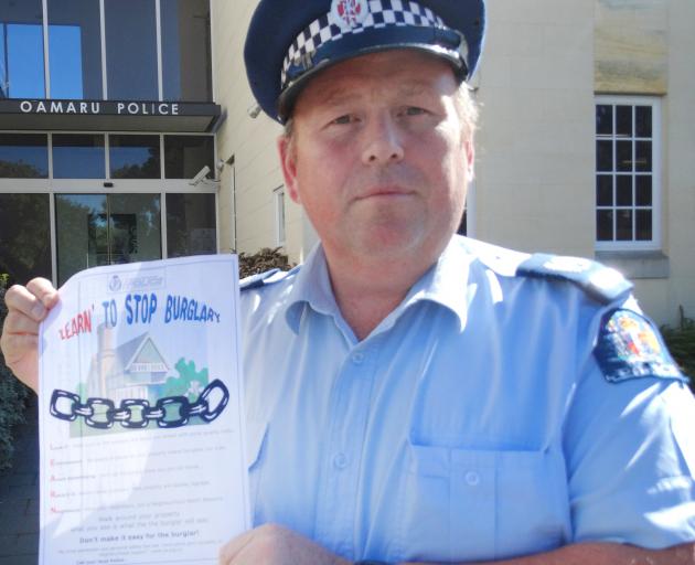 Senior Sergeant Jason McCoy, of Oamaru, with a home security questionnaire being handed out to...