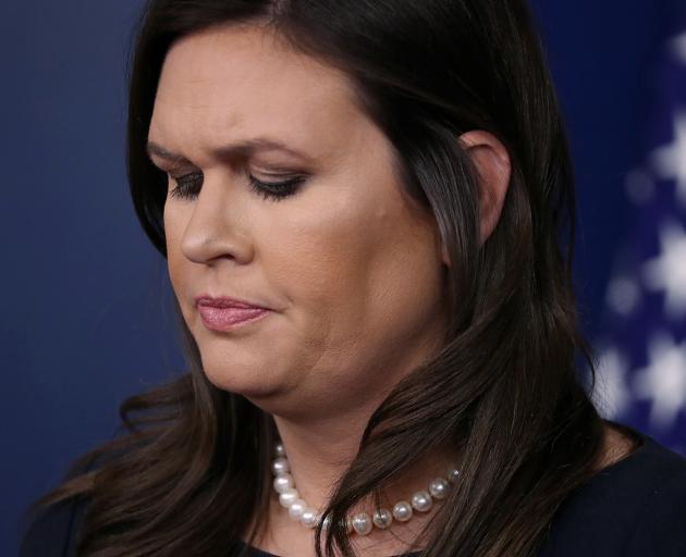 White House Press Secretary Sarah Sanders pauses as she answers a question from a reporter during...