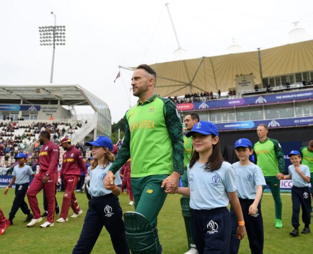 Faf Du Plessis leads South Africa on to the field for their ultimately washed out World Cup match...