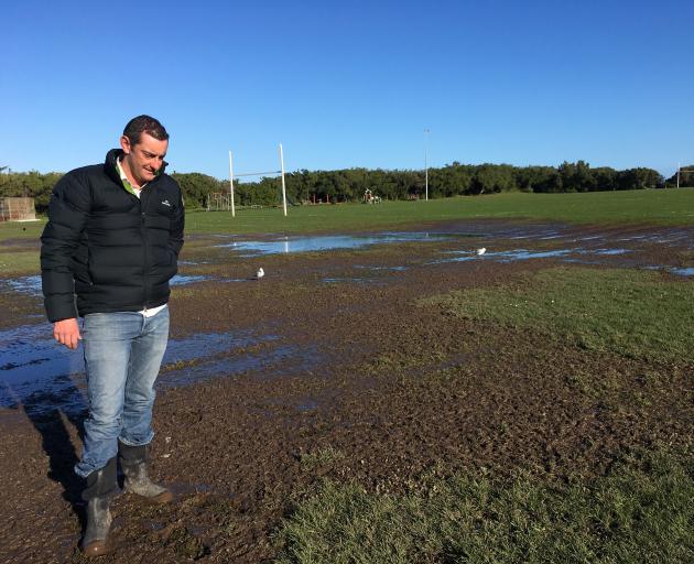 Saddle Hill Community Board chairman Scott Weatherall inspects a muddy section of a rugby field in Brighton Domain last week. Photo: Shawn McAvinue Saddle Hill Community Board chairman Scott Weatherall inspects a muddy section of a rugby field in Brighton Domain last week. Photo: Shawn McAvinue