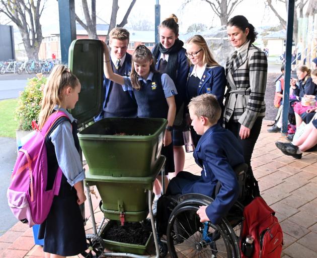 Taieri College envirogroup members inspecting one of their worm farms at the school are ...
