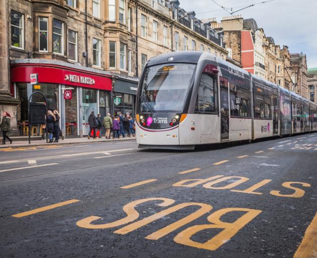 An electric tram glides through central Edinburgh. Photo: Getty Images 