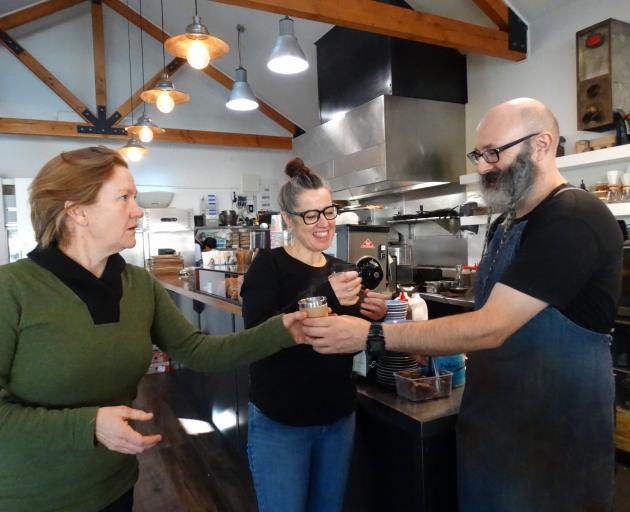 Plastic Free Wanaka's Sophie Ward (left) and Federal Diner owner Brona Parsons taste-test a takeaway coffee made by barista Robert Holt in a reusable cup. Photo: Kerrie Waterworth
