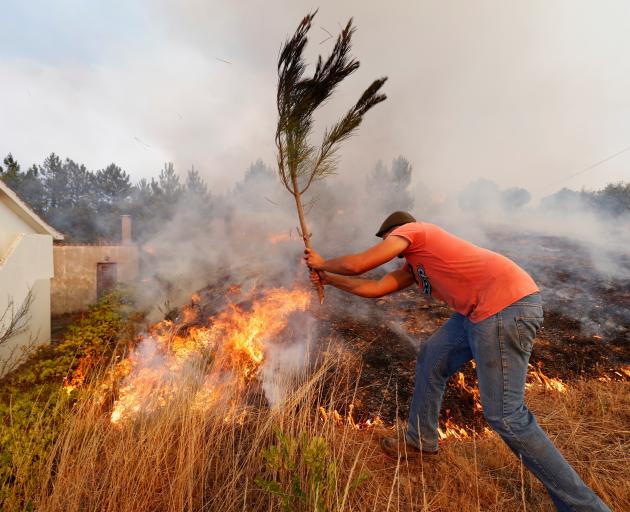 Portugal's Civil Protection said some houses were destroyed by the flames but did not give a specific number. Photo: Reuters Portugal's Civil Protection said some houses were destroyed by the flames but did not give a specific number. Photo: Reuters